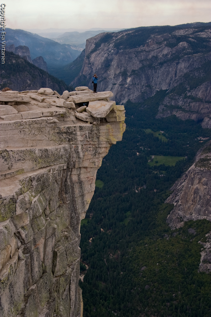 Man defying certain death on Half-Dome.